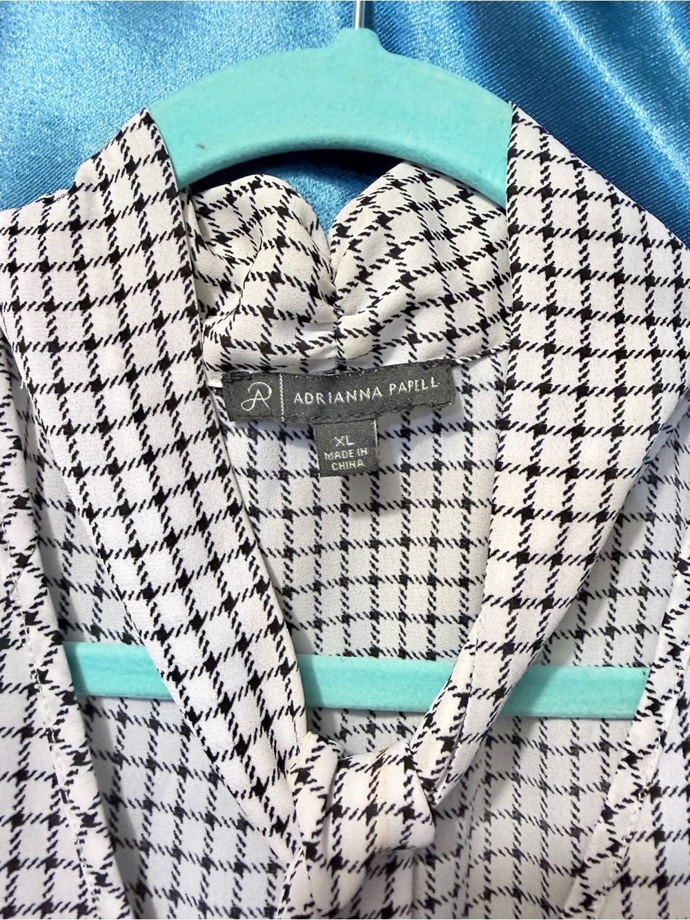 Black and white sleeveless blouse with tie neckline.